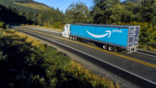 semi truck hauling Amazon trailer over highway