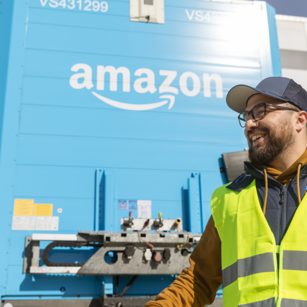 trucker wearing safety equipment in an amazon truck yard