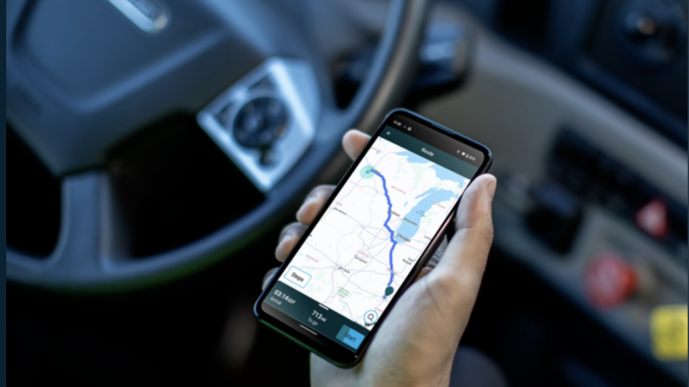 trucker holding the mobile gps for a load.png