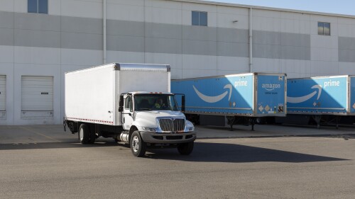box truck in amazon prime truck yard next to prime trailers