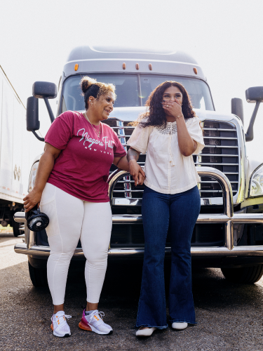 Mia McCray and Lakeisha Anderson standing in front of a semi-truck
