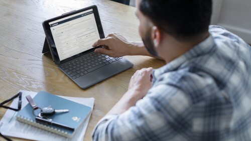 man using an ipad to access Amazon Relay load board