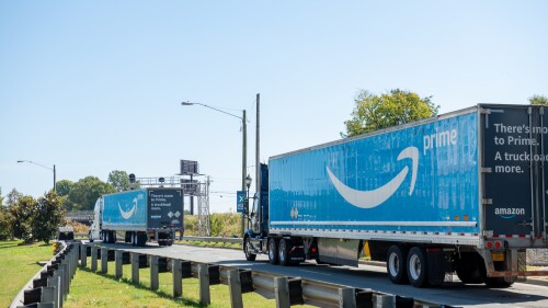 two semi trucks hauling amazon prime trailers.jpg