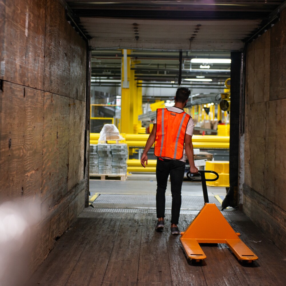 trucking yard worker loading a trailer