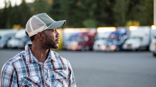 trucker standing in a truck yard