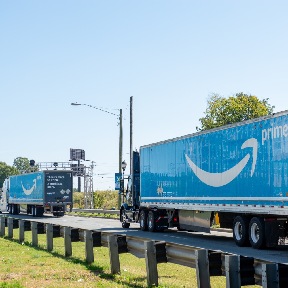 two semi trucks hauling amazon prime trailers.jpg