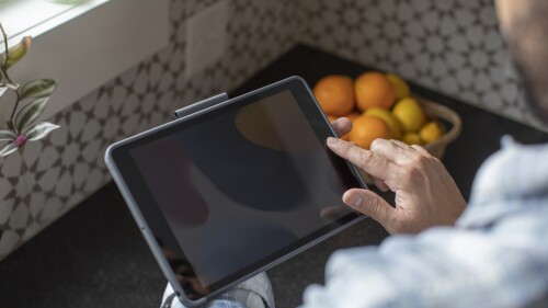 man using tablet to book trucking contracts on amazon relay