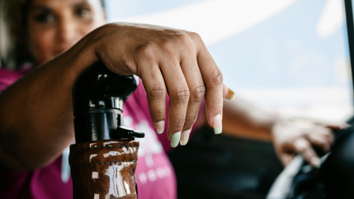 close-up of woman's hand on semi-truck shift
