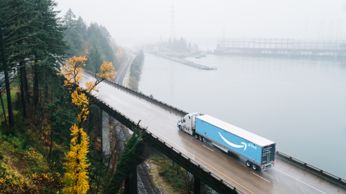 semi-truck hauling an amazon trailer on the highway