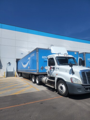 power-only truck parked with amazon prime trailer at dock door