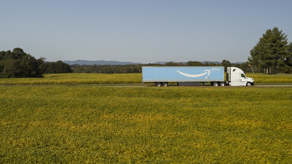 amazon prime trailer being hauled across field of flowers
