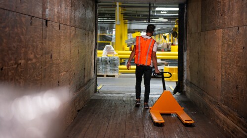 trucking yard worker loading a trailer