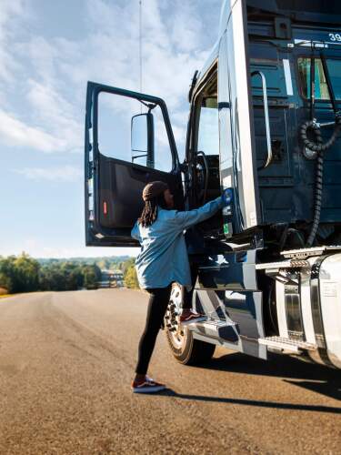 driver climbing into semi cab.jpg