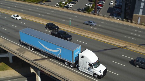 Amazon prime truck driving down a highway