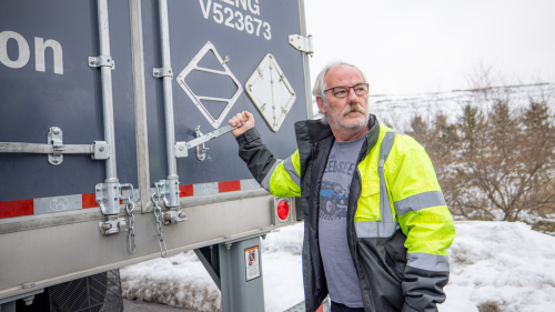 truck driver behind a semi trailer in snow