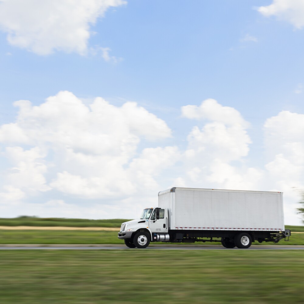 white box truck driving through the country.jpg