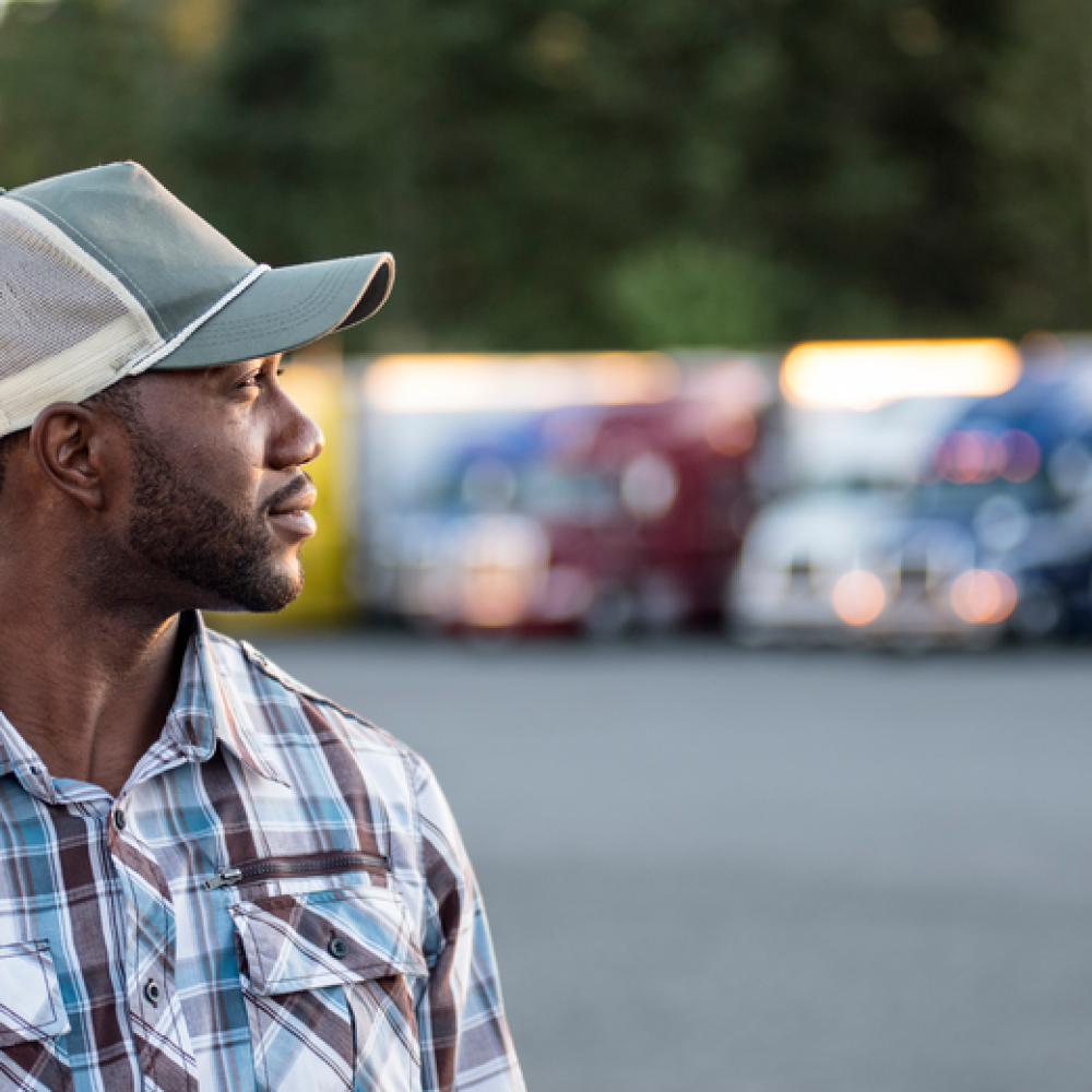 trucker standing in a truck yard