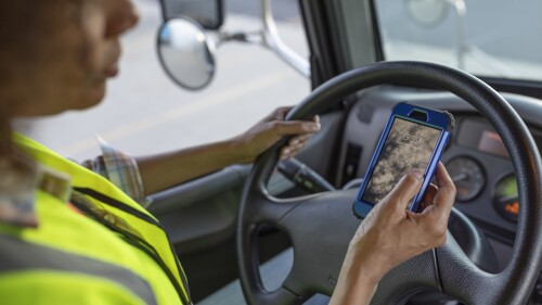 driver on phone in box truck