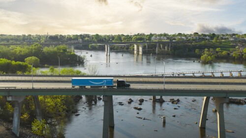 tractor hauling amazon prime trailer over southern bridge