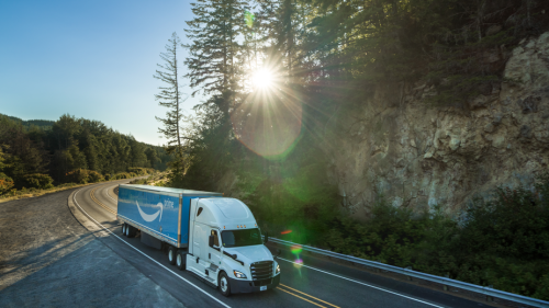 semi hauling next to a rocky cliff at sunset.png