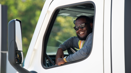 smiling driver in semi cab.png