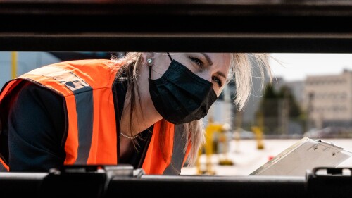 close up of a trucker inspecting a vehicle.jpg