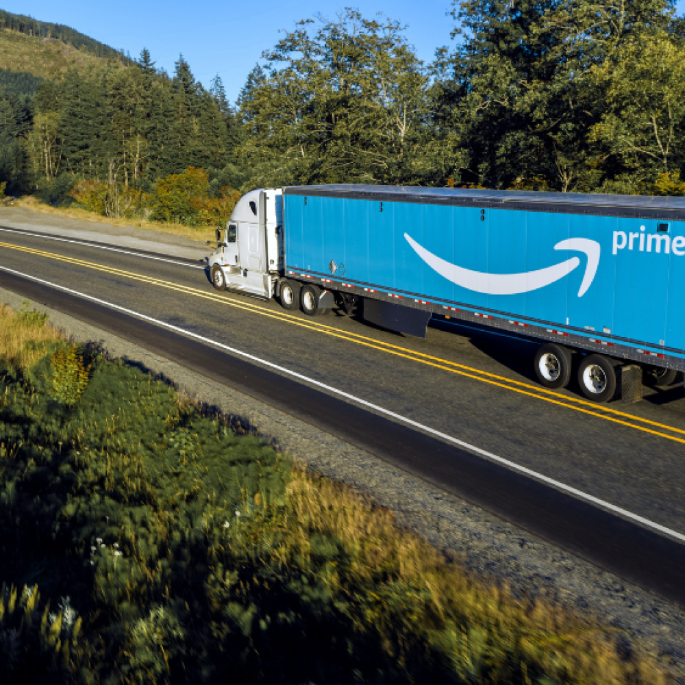 semi truck hauling Amazon trailer over highway