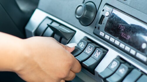 trucker turning on air conditioning in semi cab