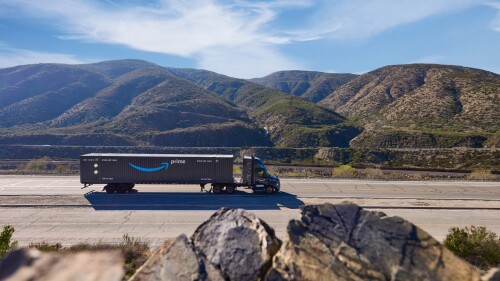 truck hauling amazon prime intermodal trailer through mountains