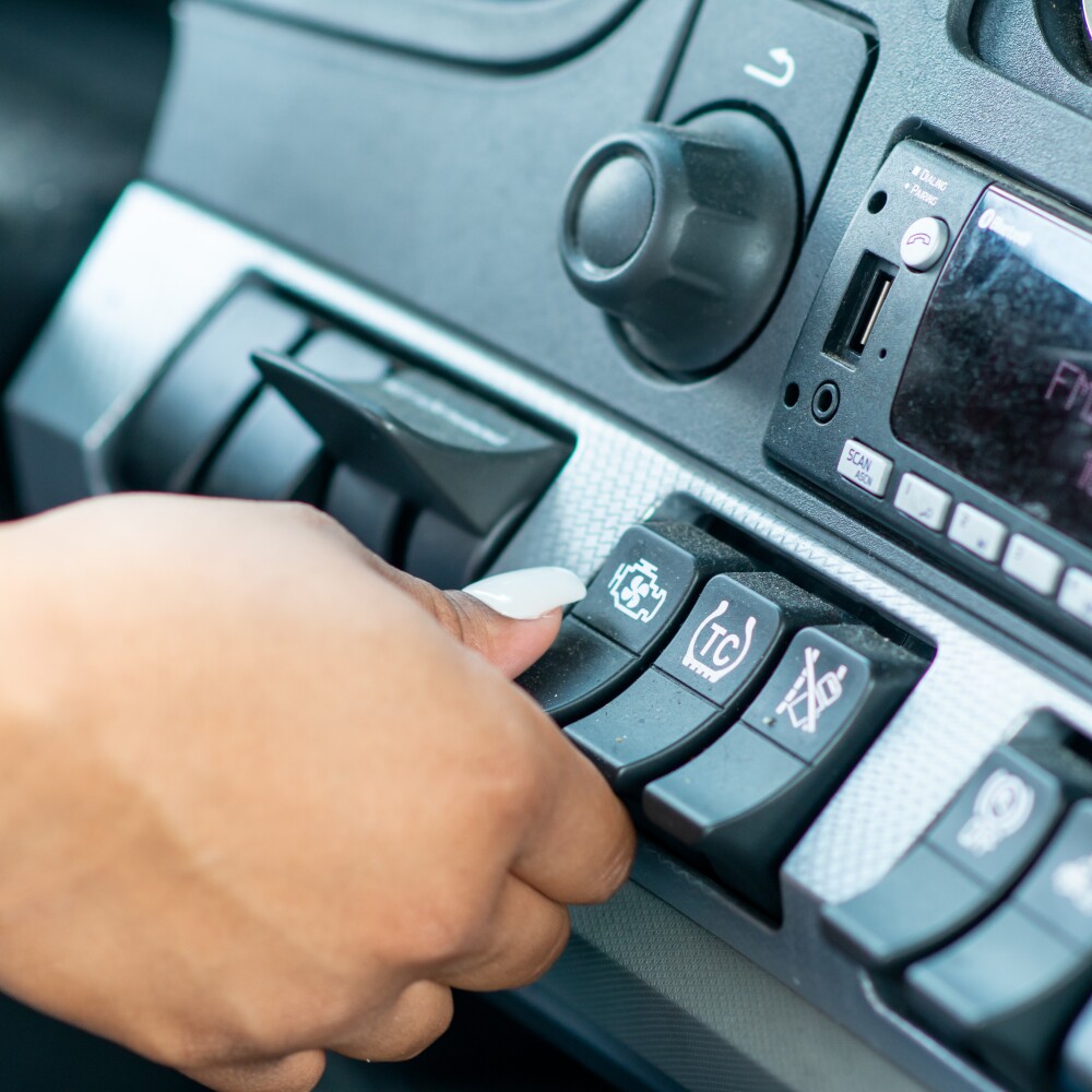 trucker turning on air conditioning in semi cab